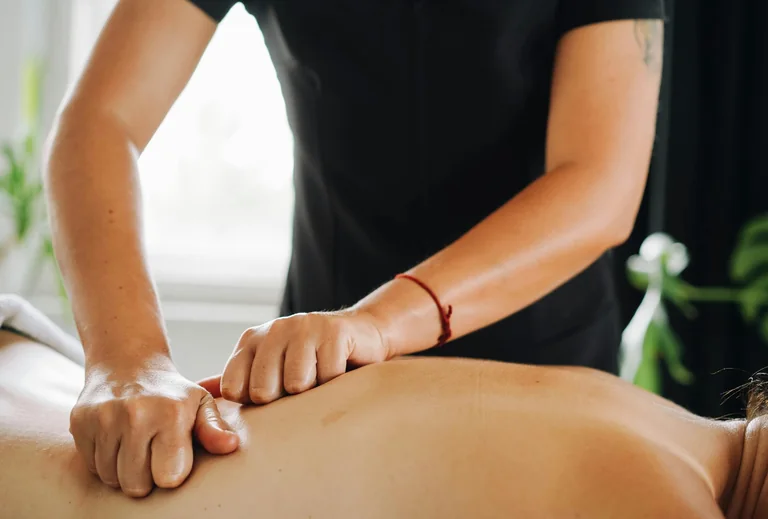 Massage therapist working on a patient’s back